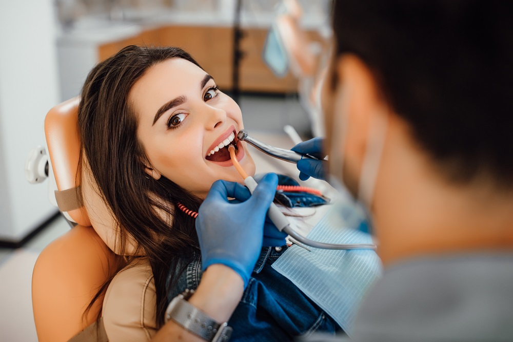 dentist performing dental cleaning procedure