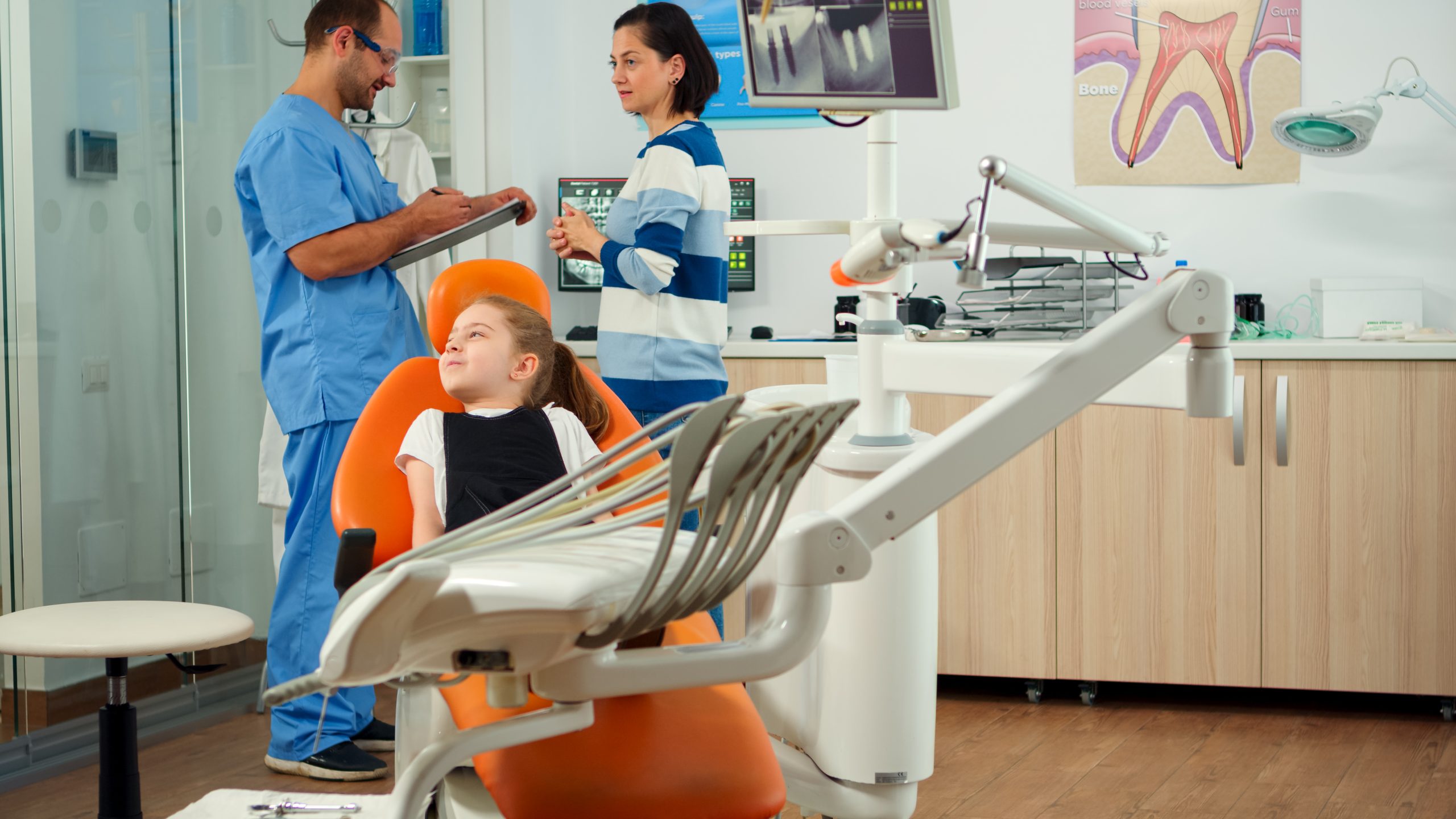 Man nurse inviting kid patient in consultation dental room
